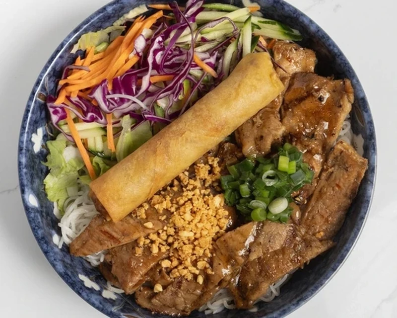 Grilled Pork noodle bowl with a fried pork spring roll and crushed peanuts at Bon Vietnamese Cuisine, Redstone, Calgary